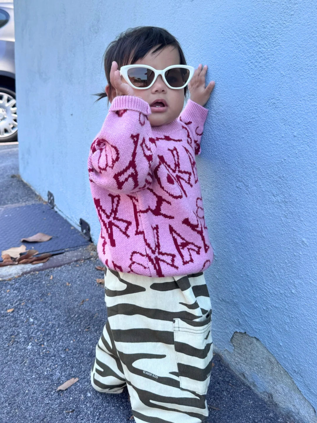 child wearing the okay sweater in pink
