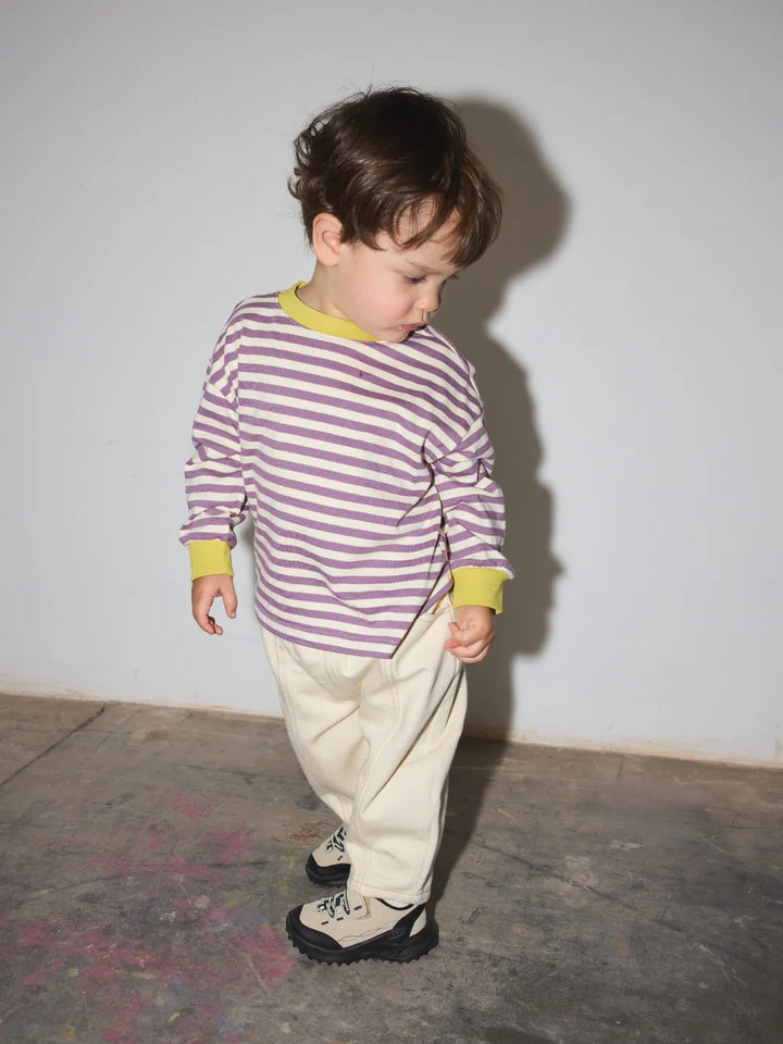 child wearing the striped longsleeve in purple and ecru