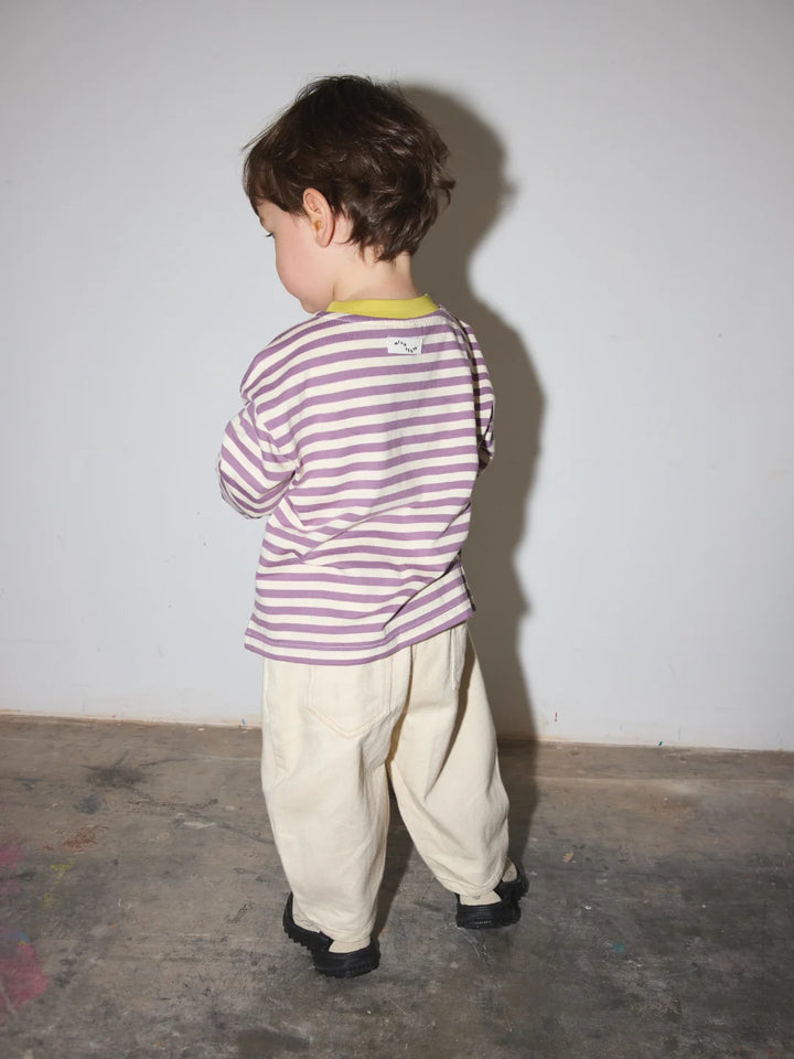 child wearing the striped longsleeve in purple and ecru